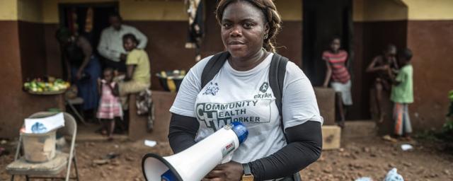 89771_ogb_main_community_health_worker.jpg Aminata is one of Oxfam's Community Health Workers in Sierra Leone. She teaches the community about the signs and symptoms of Ebola, about how to prevent it and what to do if a family member becomes infected. Photo: Pablo Tosco/Oxfam