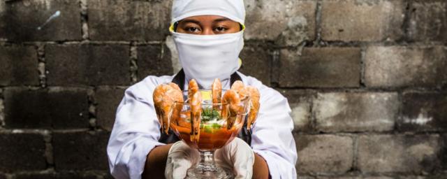 Melati, 18, worked in an Indonesian shrimp factory. She was expected to peel 600 shrimps an hour. When cleaning the conveyor belt with a chlorine mixture, she burned her hands because she was not given the proper safety equipment. Photo: Adrian Mulya. Melati, 18, worked in an Indonesian shrimp factory. She was expected to peel 600 shrimps an hour. When cleaning the conveyor belt with a chlorine mixture, she burned her hands because she was not given the proper safety equipment. Photo: Adrian Mulya.