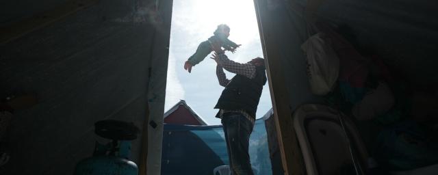 A father plays with his 3-year-daughter in the middle of his tent in Rafah which he took refuge after losing his house and factory. A father plays with his 3-year-daughter in the middle of his tent in Rafah which he took refuge after losing his house and factory.