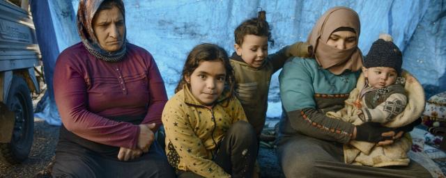 Aziza Ahmed, her three children and a woman.